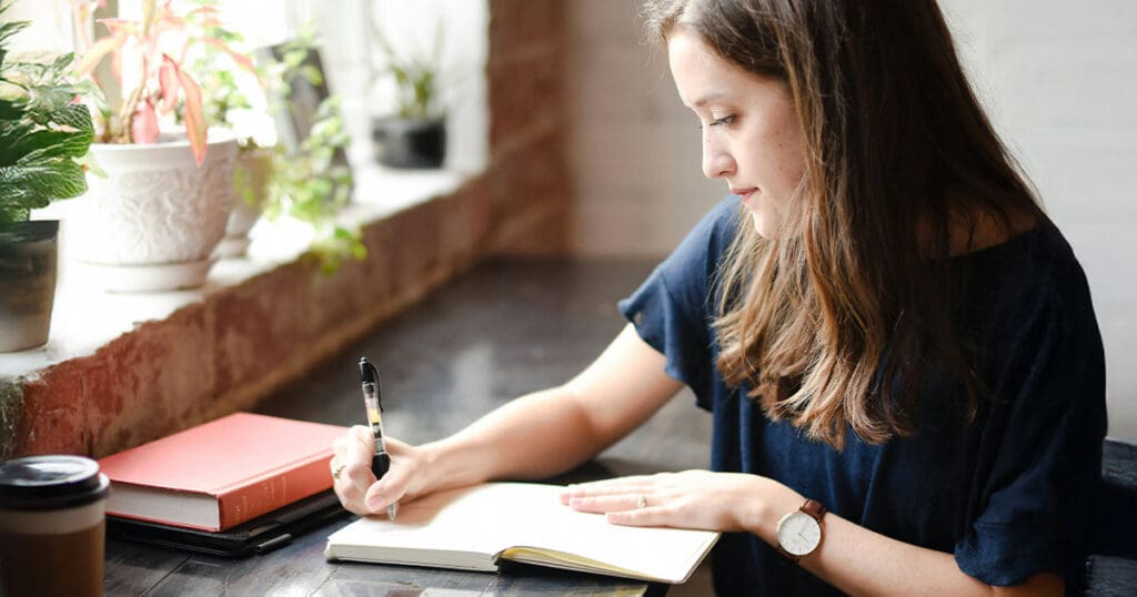 woman writing in a journal